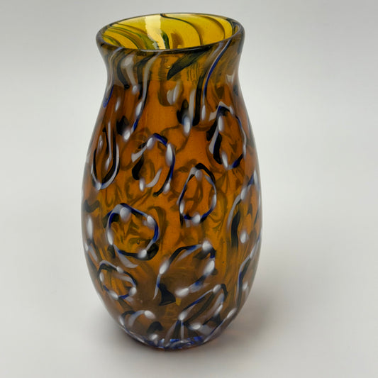 Blue-white spiral on amber vase