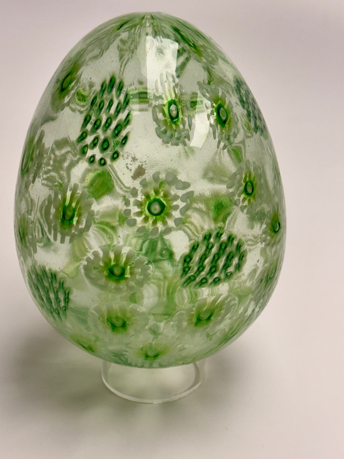 Green, white, and clear “jeweled" seven-inch egg. Handblown murrine glass art.