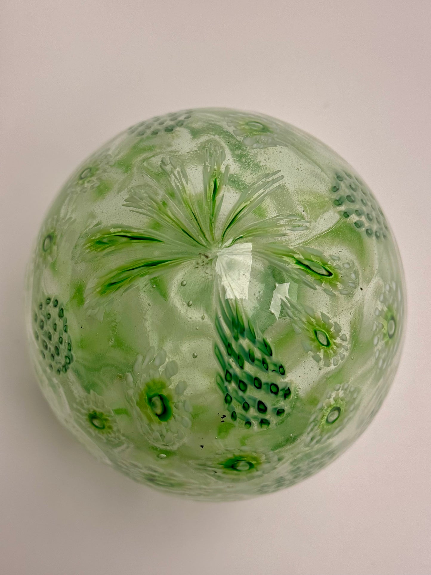Green, white, and clear “jeweled" seven-inch egg. Handblown murrine glass art.