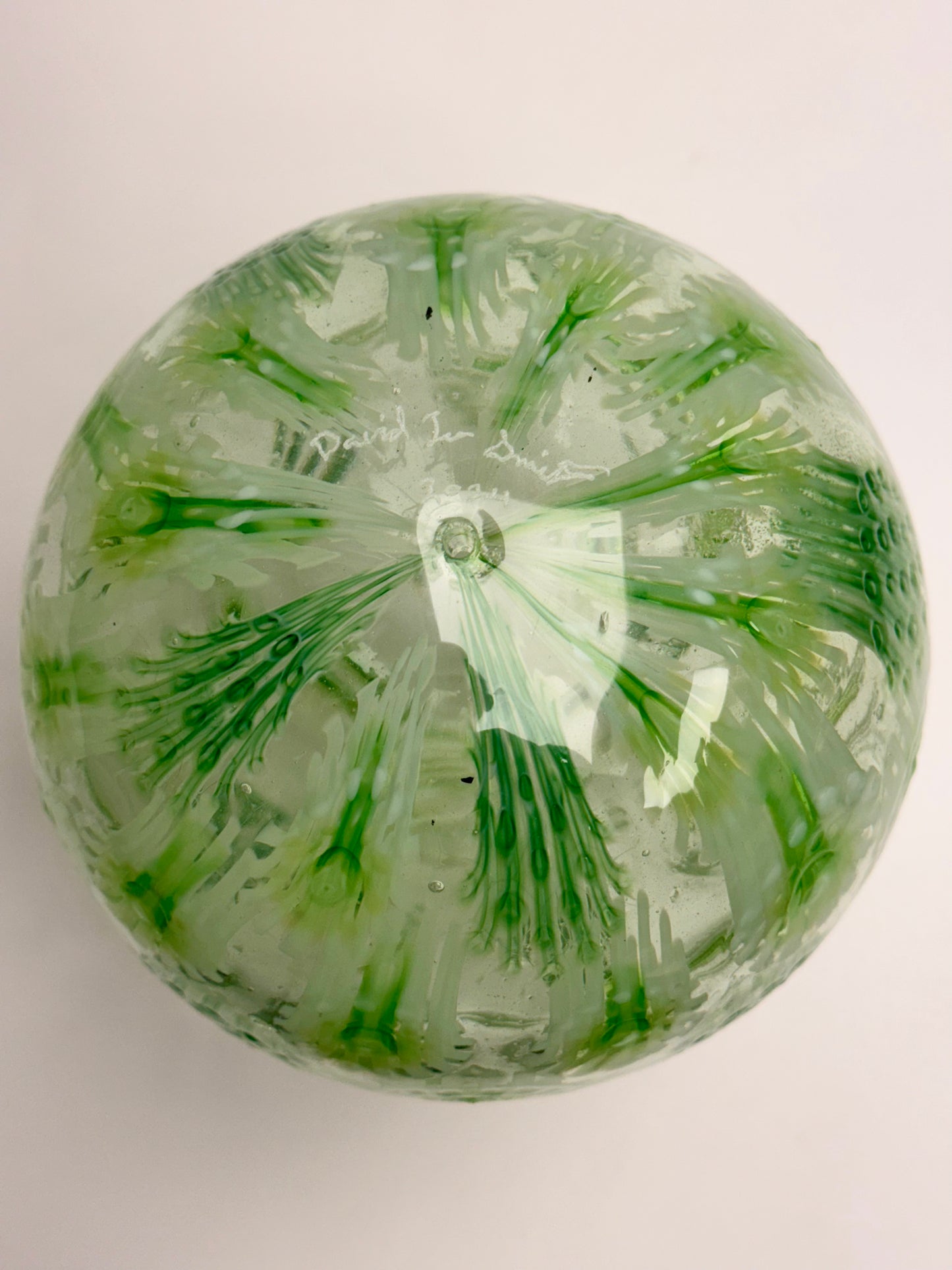 Green, white, and clear “jeweled" seven-inch egg. Handblown murrine glass art.
