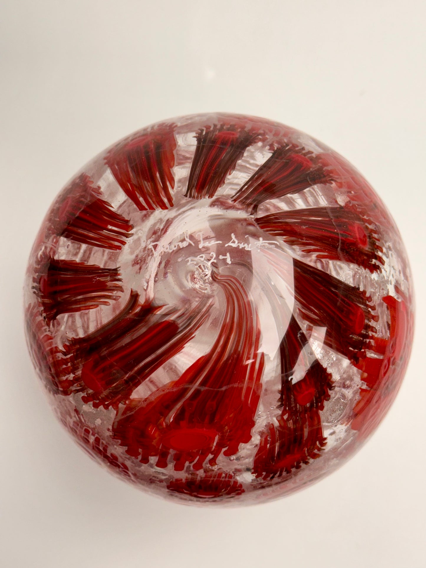 Red and silver “jeweled" seven-inch egg. Handblown murrine glass art.