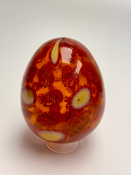 Red, cream and gold “jeweled" six-inch egg. Handblown murrine glass art.