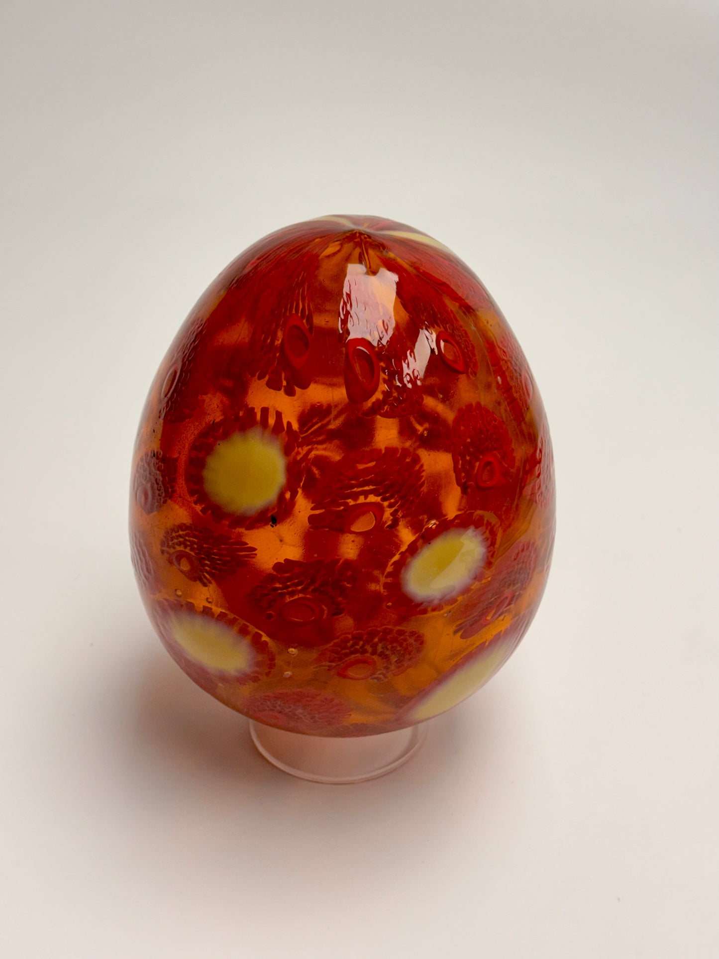 Red, cream and gold “jeweled" six-inch egg. Handblown murrine glass art.