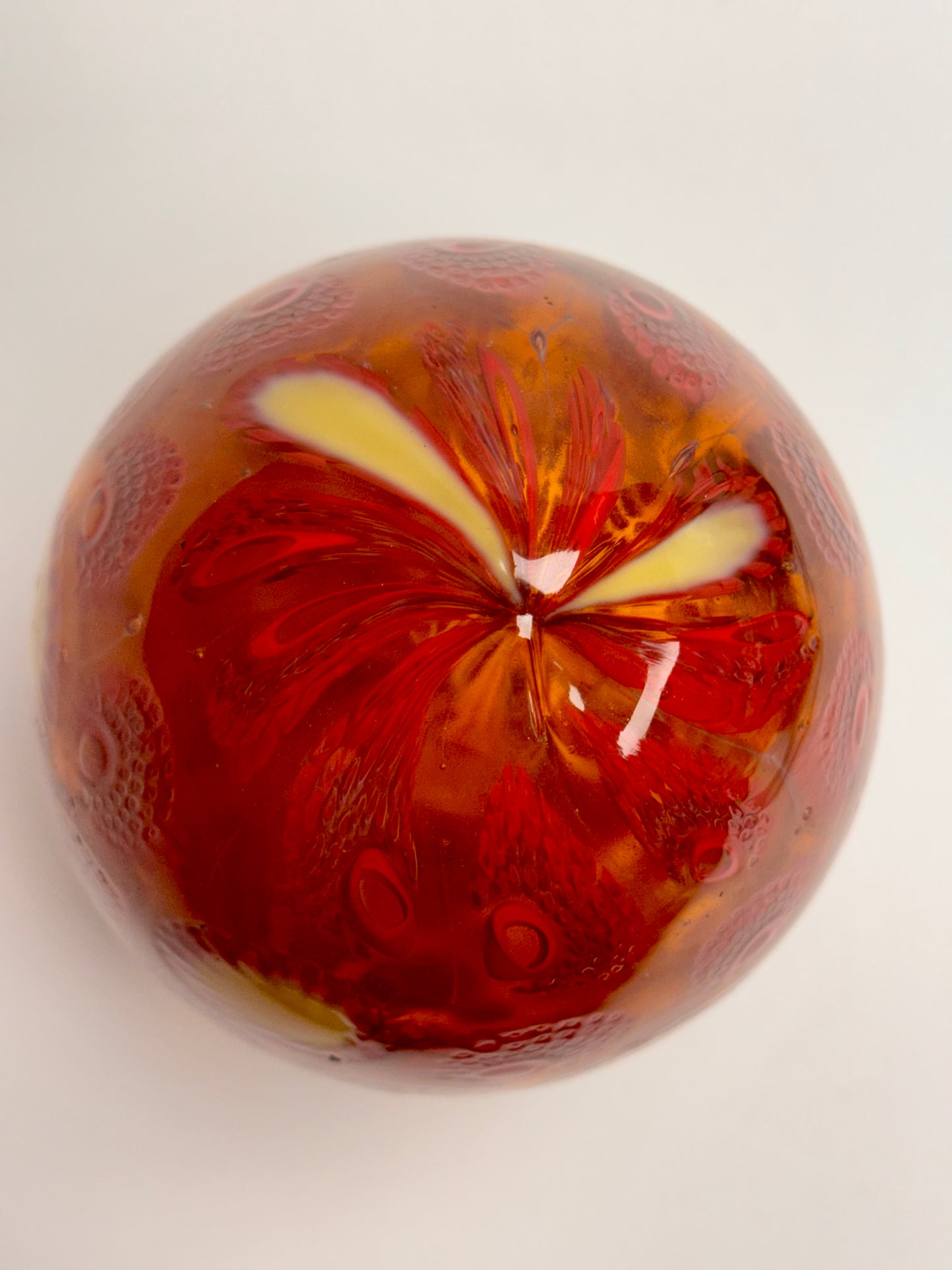 Red, cream and gold “jeweled" six-inch egg. Handblown murrine glass art.